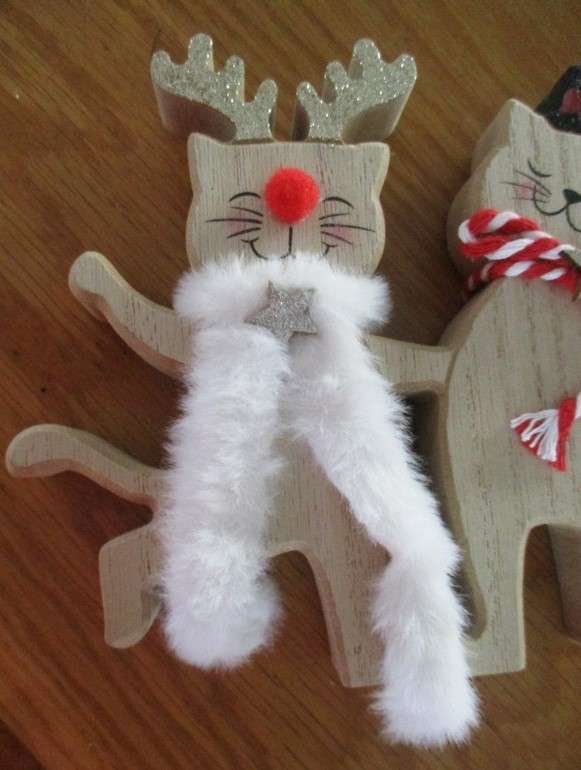 A trio of cheerful wooden cats for the festive table