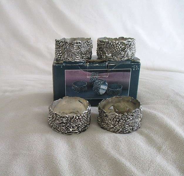 Four ornate silver plated antique finish napkin/serviette rings - original box - excellent condition