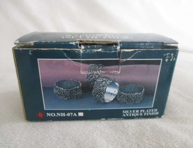 Four ornate silver plated antique finish napkin/serviette rings - original box - excellent condition
