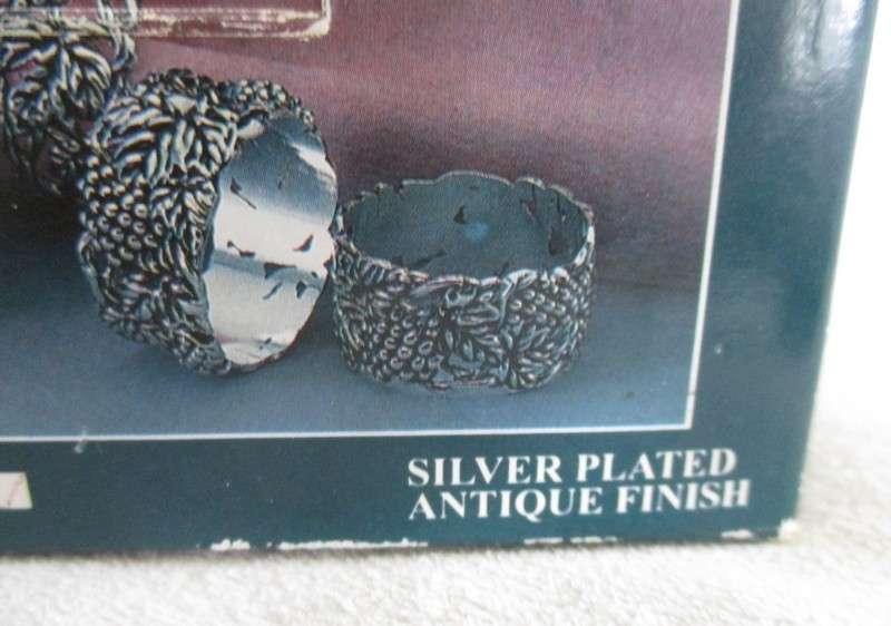Four ornate silver plated antique finish napkin/serviette rings - original box - excellent condition