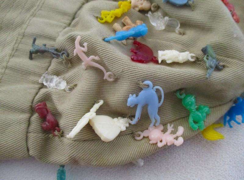Vintage plastic charms - 62 of them on an old khaki hat!