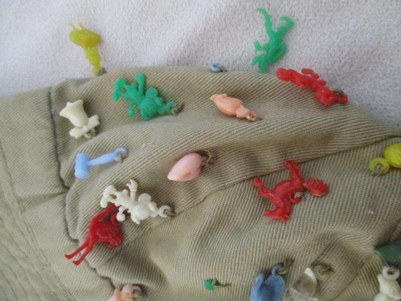 Vintage plastic charms - 62 of them on an old khaki hat!