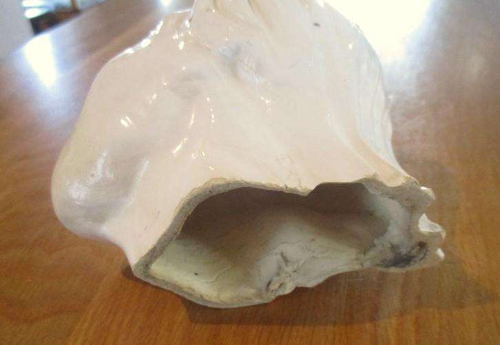 A vintage shabby chic glazed pottery head for inside or outside