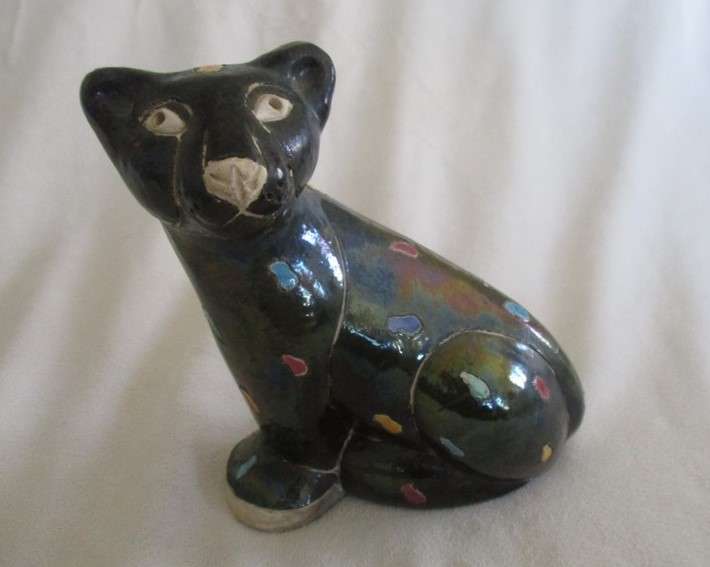 A unique, Unusual Raku leopard glazed in iridescent colours - initialled by artist