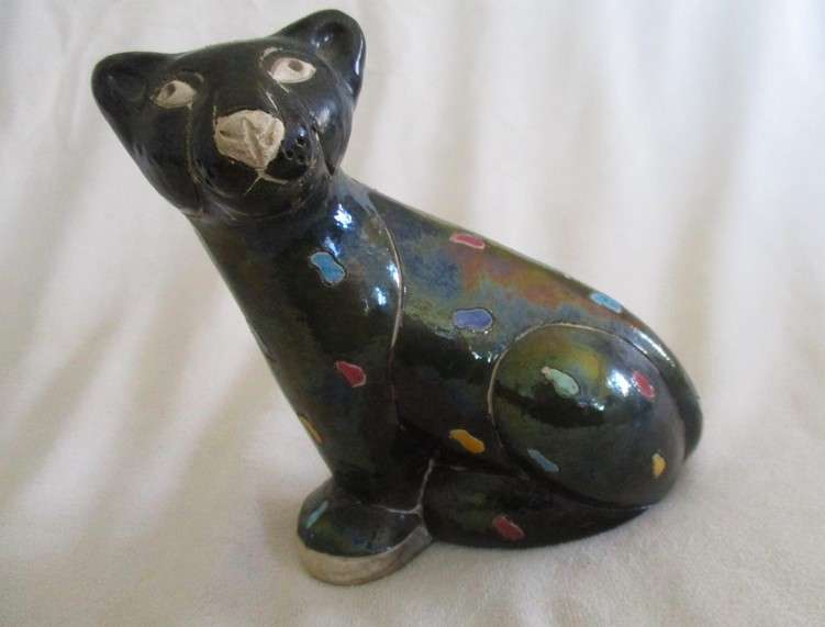 A unique, Unusual Raku leopard glazed in iridescent colours - initialled by artist