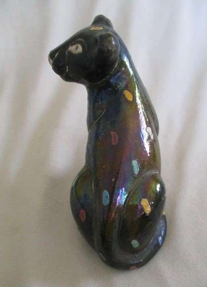 A unique, Unusual Raku leopard glazed in iridescent colours - initialled by artist