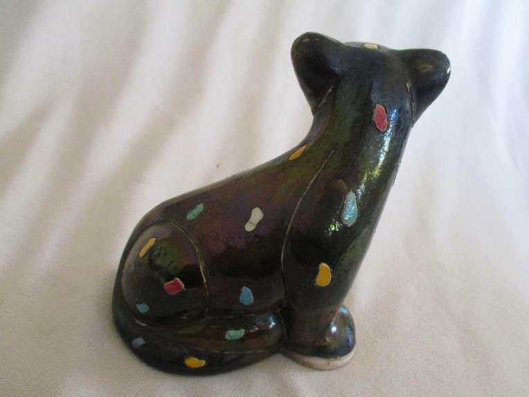 A unique, Unusual Raku leopard glazed in iridescent colours - initialled by artist