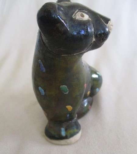 A unique, Unusual Raku leopard glazed in iridescent colours - initialled by artist