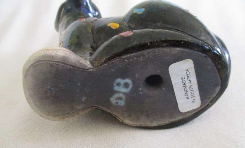 A unique, Unusual Raku leopard glazed in iridescent colours - initialled by artist