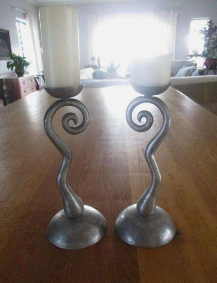 Two ornate pewter candle holders