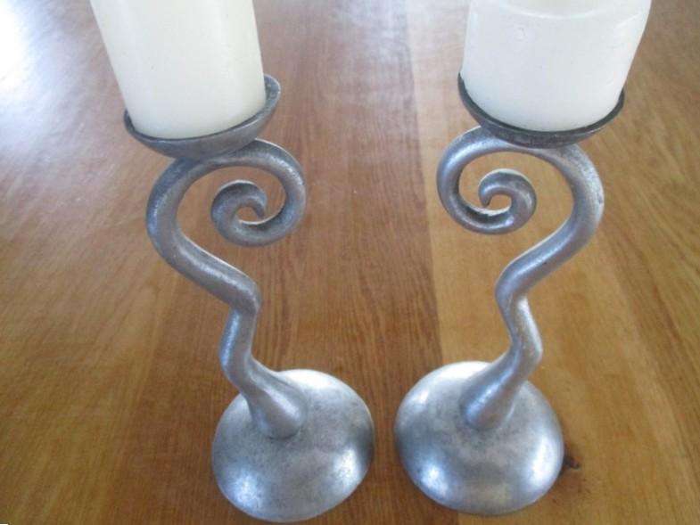 Two ornate pewter candle holders