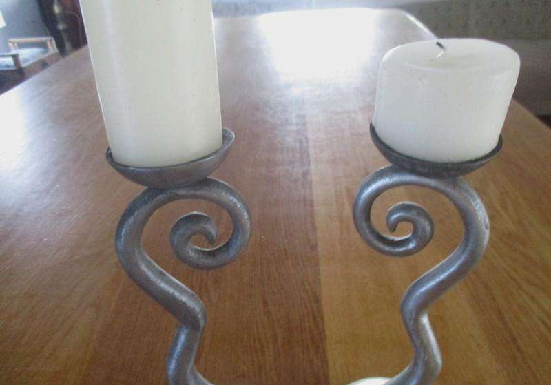 Two ornate pewter candle holders