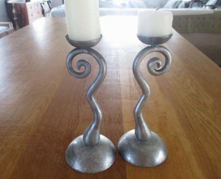 Two ornate pewter candle holders