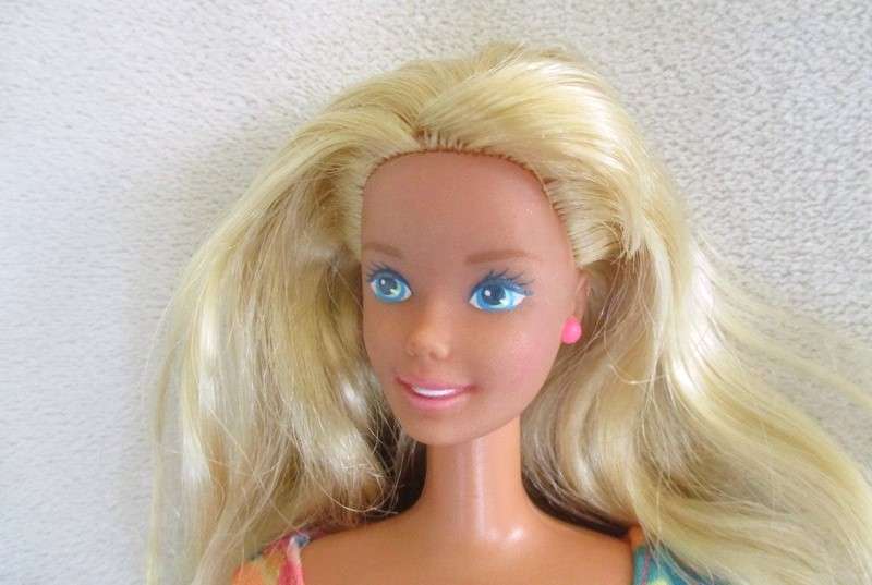 A Vintage 1980's Mattel Barbie doll with knees that bend in pretty jumpsuit