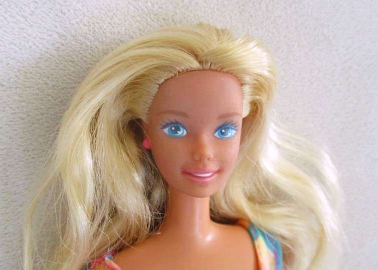 A Vintage 1980's Mattel Barbie doll with knees that bend in pretty jumpsuit