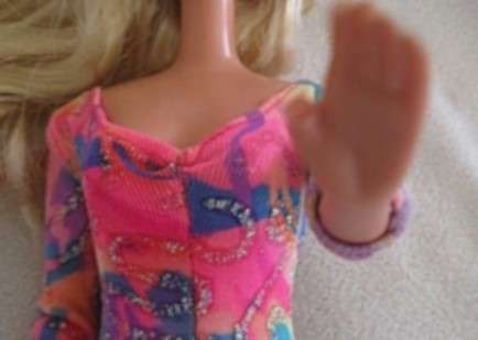 A Vintage 1980's Mattel Barbie doll with knees that bend in pretty jumpsuit