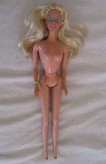 A Vintage 1980's Mattel Barbie doll with knees that bend in pretty jumpsuit