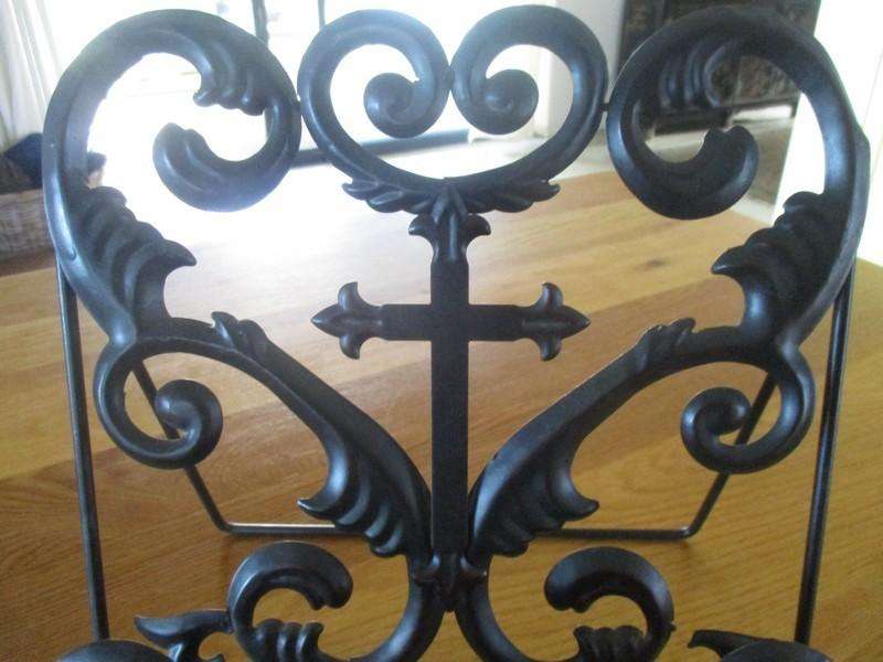 A beautiful ornate metal Bible/book stand with Fleurs-de-lis Cross
