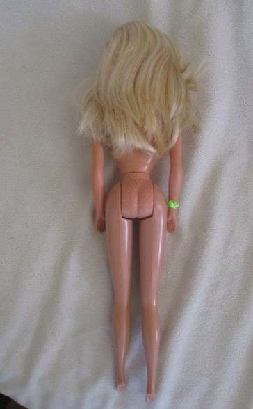 A Vintage 1980's Mattel Barbie doll with knees that bend in pretty jumpsuit