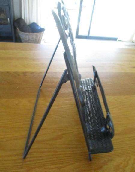 A beautiful ornate metal Bible/book stand with Fleurs-de-lis Cross