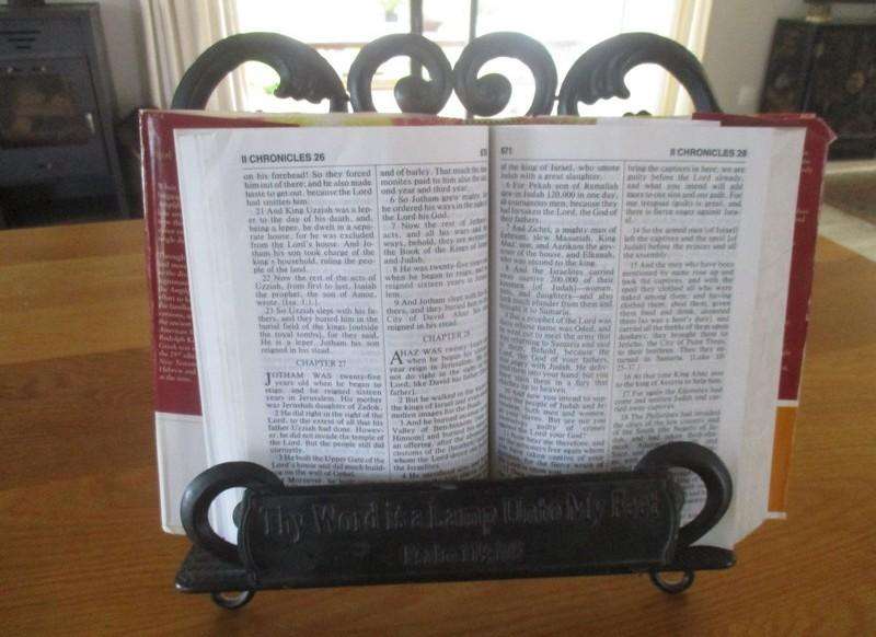 A beautiful ornate metal Bible/book stand with Fleurs-de-lis Cross