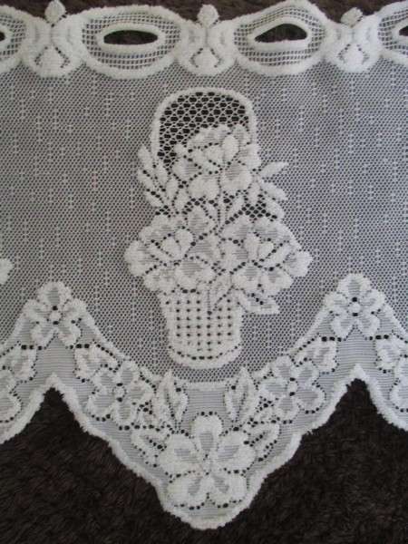 A special vintage `half mast` lace curtain with textured flowers in basket design