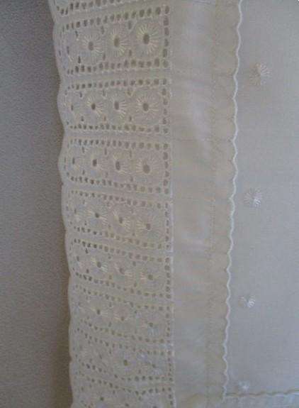 Pretty cushion with wide embroidered lace border
