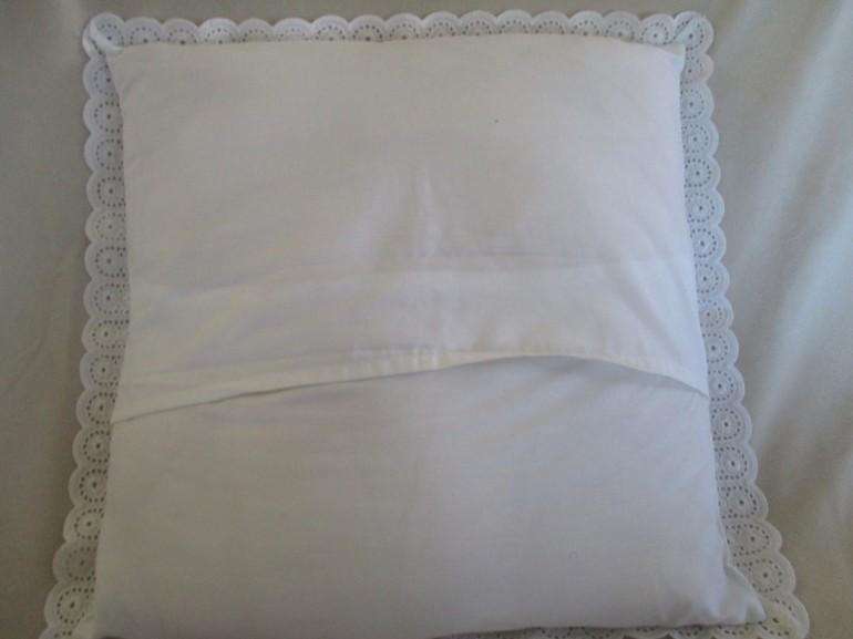 Pretty cushion with wide embroidered lace border