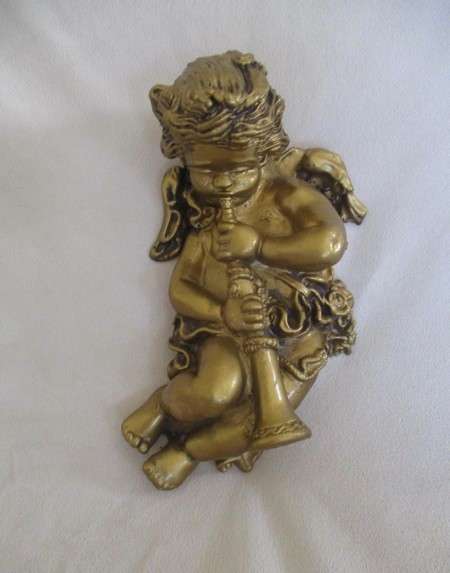 A cute larger size cherub wall plaque - cherub blowing trumpet