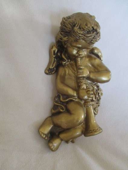 A cute larger size cherub wall plaque - cherub blowing trumpet