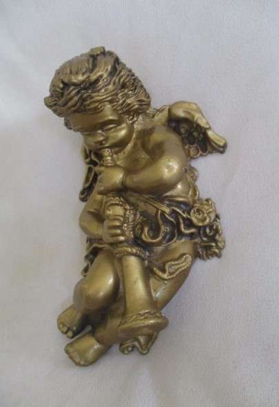 A cute larger size cherub wall plaque - cherub blowing trumpet