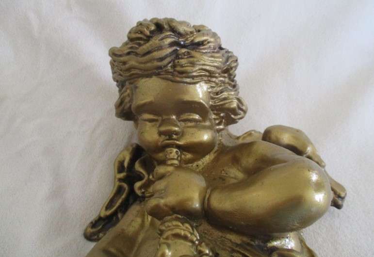 A cute larger size cherub wall plaque - cherub blowing trumpet