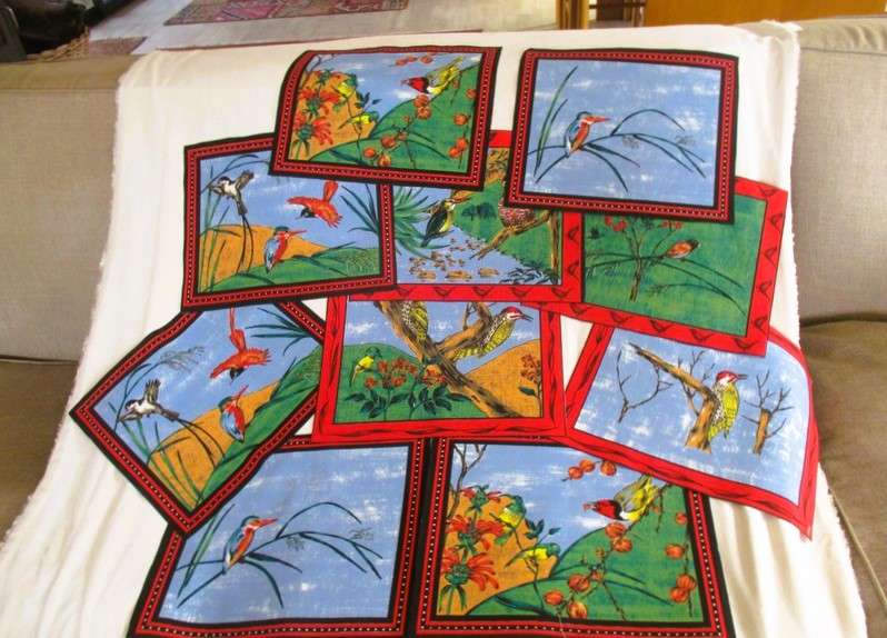 Ten material placemats with colourful bird designs