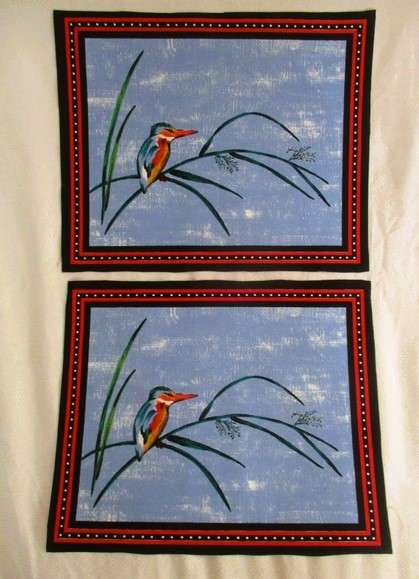 Ten material placemats with colourful bird designs