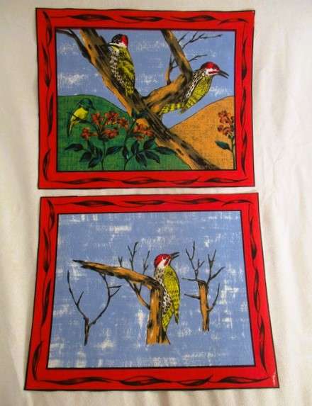 Ten material placemats with colourful bird designs