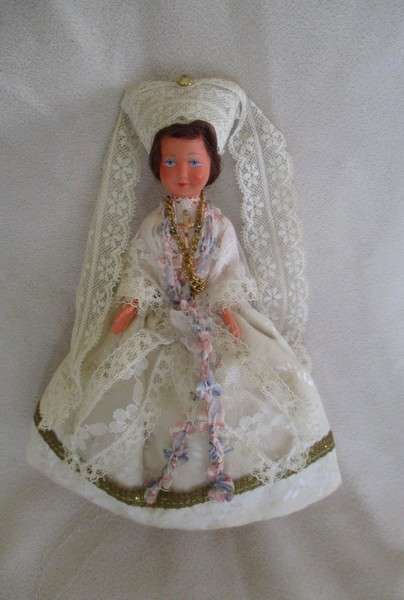 Small vintage doll in religious garb