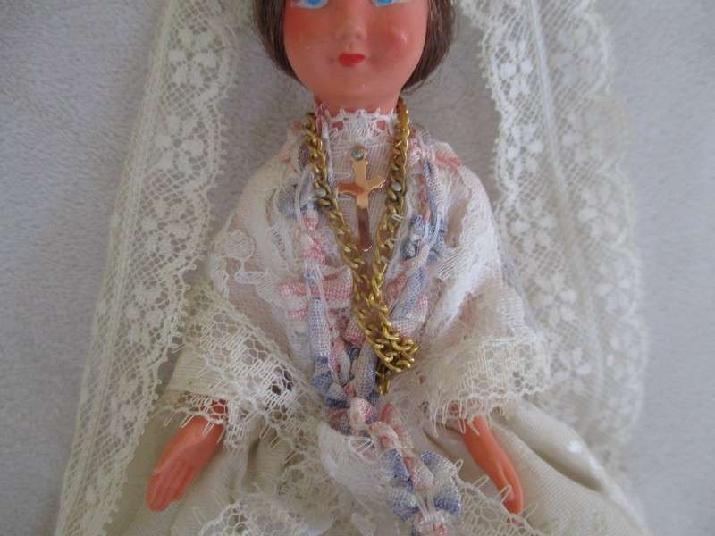 Small vintage doll in religious garb