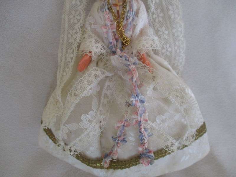 Small vintage doll in religious garb