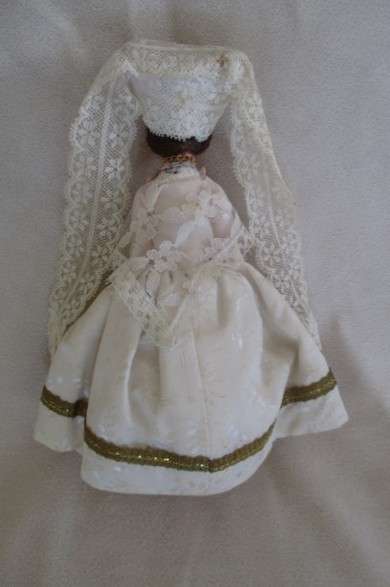 Small vintage doll in religious garb