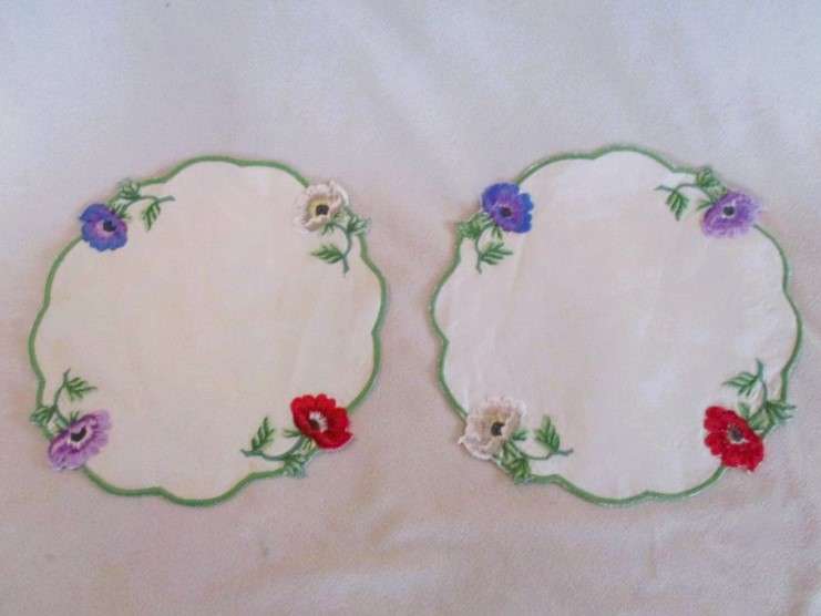 Two beautifully embroidered doilies with colourful anemones