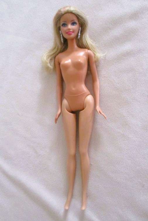 A very pretty Mattel Barbie with original earrings and knees that bend - lovely "fur" lined coat