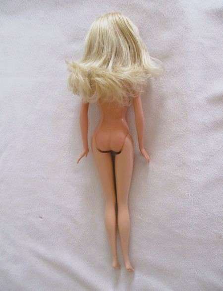 A very pretty Mattel Barbie with original earrings and knees that bend - lovely "fur" lined coat