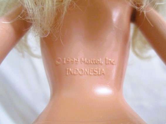 A very pretty Mattel Barbie with original earrings and knees that bend - lovely "fur" lined coat