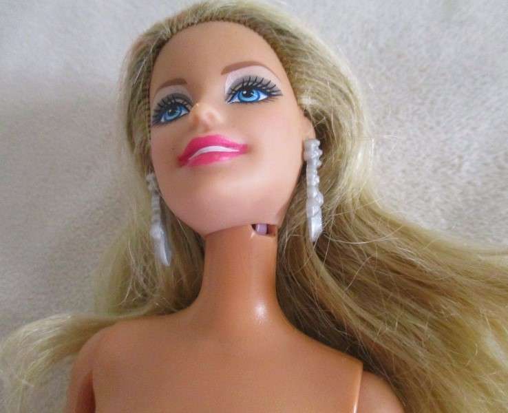 A very pretty Mattel Barbie with original earrings and knees that bend - lovely "fur" lined coat