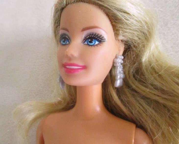 A very pretty Mattel Barbie with original earrings and knees that bend - lovely "fur" lined coat