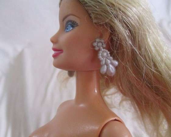 A very pretty Mattel Barbie with original earrings and knees that bend - lovely "fur" lined coat