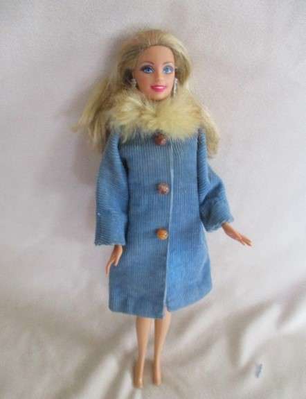 A very pretty Mattel Barbie with original earrings and knees that bend - lovely "fur" lined coat