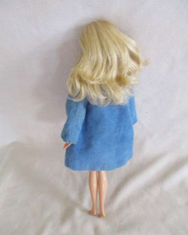 A very pretty Mattel Barbie with original earrings and knees that bend - lovely "fur" lined coat