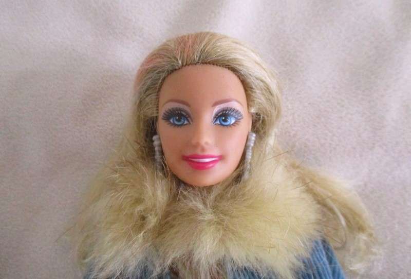 A very pretty Mattel Barbie with original earrings and knees that bend - lovely "fur" lined coat
