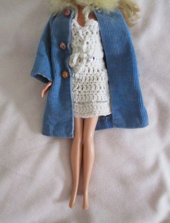 A very pretty Mattel Barbie with original earrings and knees that bend - lovely "fur" lined coat